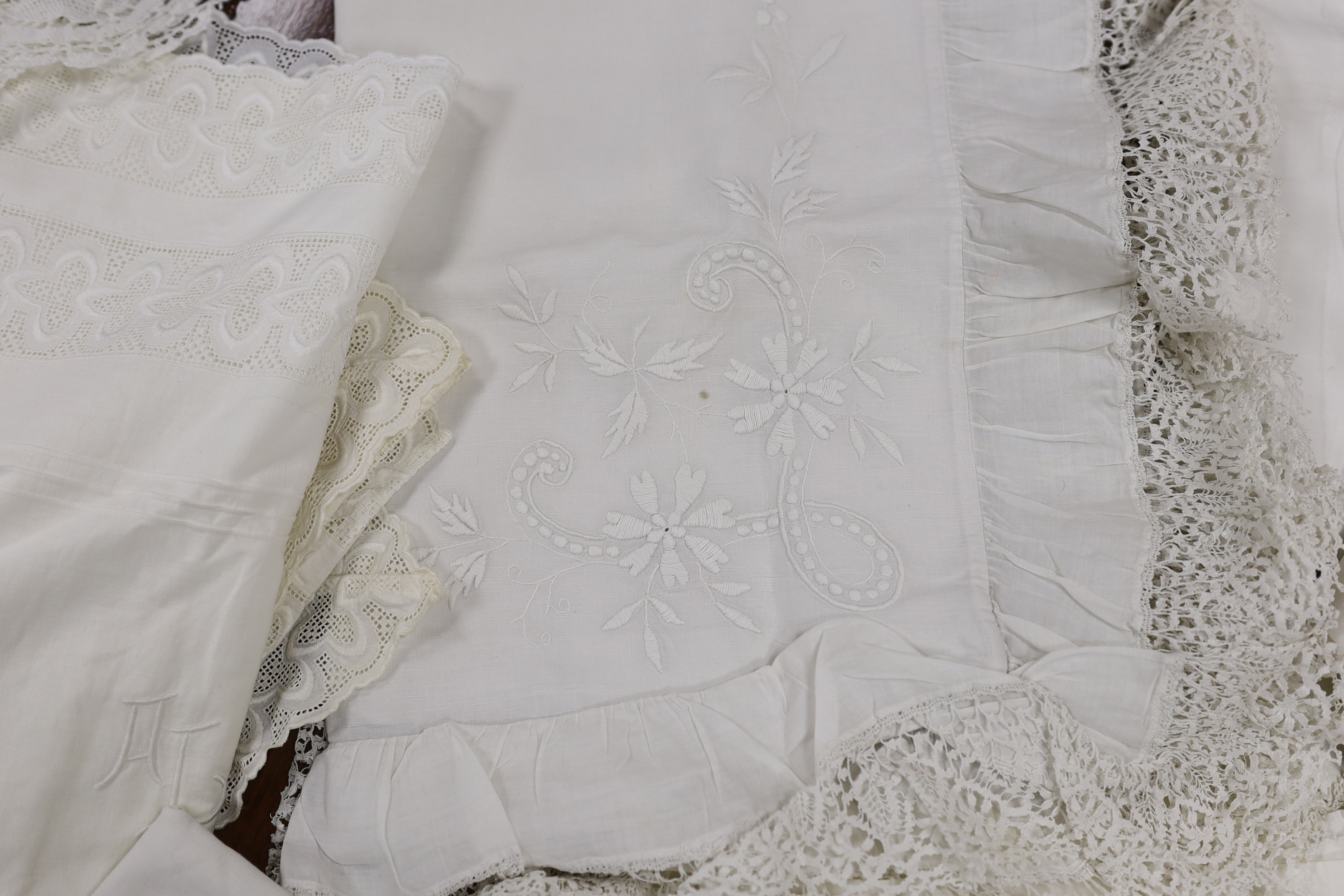 19th-20th century bed linen; a monogrammed sheet, 7ft 6in., and a smaller crochet edged sheet, a pair of French square Anglaise pillow cases, three similar appliqué pillow cases, a frilled single square pillow case and a